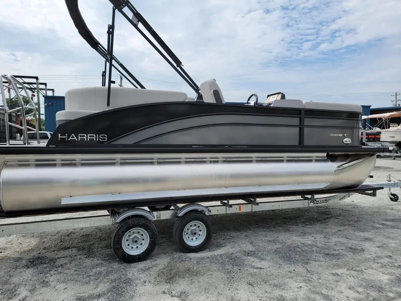 Slide: The Image of 2024 Harris Cruiser 210 pontoon boat on a trailer, side view. - 6