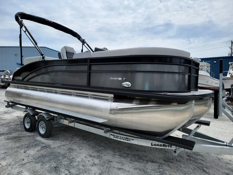 Slide: The Image of 2024 Harris Cruiser 210 pontoon boat on a Load Rite trailer. - 7