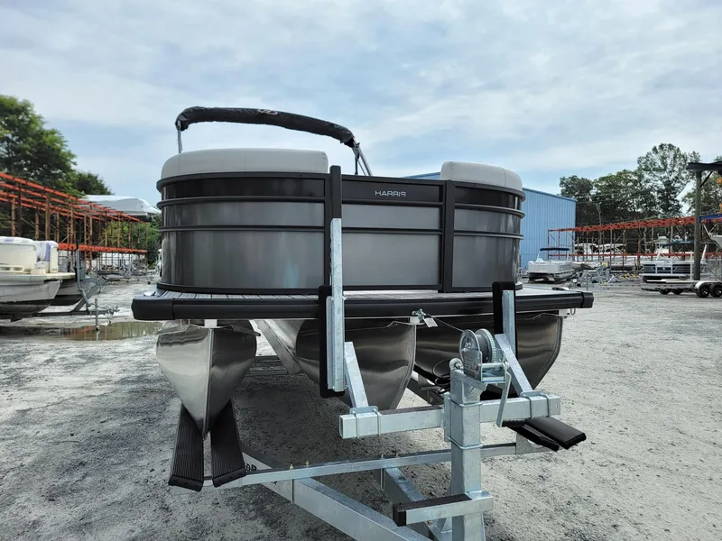 Slide: The Image of 2024 Harris Cruiser 210 pontoon boat on a trailer. - 8