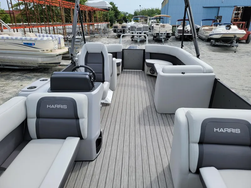 Slide: The Image of 2024 Harris Cruiser 210 pontoon boat with spacious seating and modern design. - 9