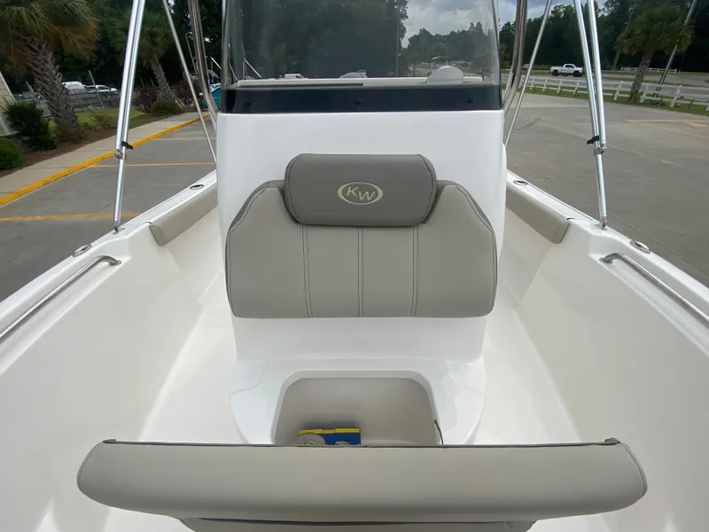 Slide: The Image of 2024 Key West 189 FS boat interior with cushioned seating and storage compartment. - 18