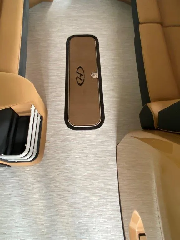 Slide: The Image of Interior of 2023 Harris FloteBote 250 Grand Mariner, featuring seating and storage compartment. - 11