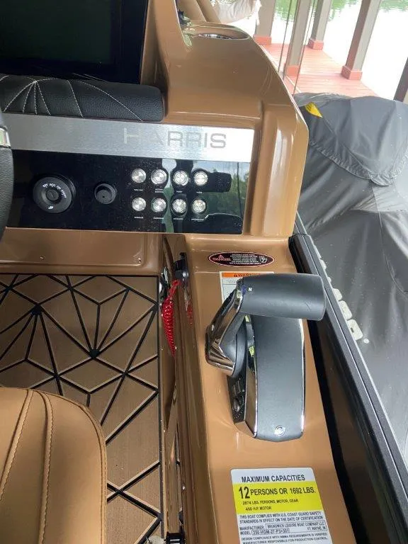 Slide: The Image of Control panel of 2023 Harris FloteBote 250 Grand Mariner boat with seating and throttle. - 15