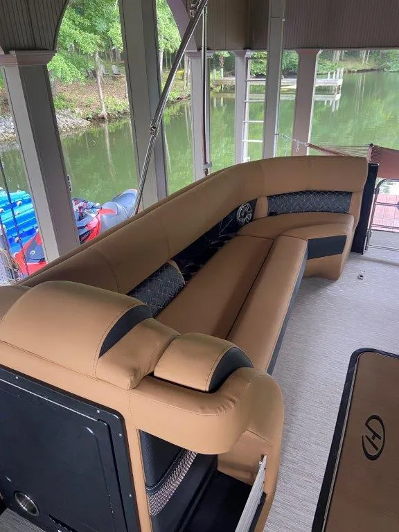 Slide: The Image of Luxurious seating on 2023 Harris FloteBote 250 Grand Mariner pontoon, docked by a serene lake. - 18