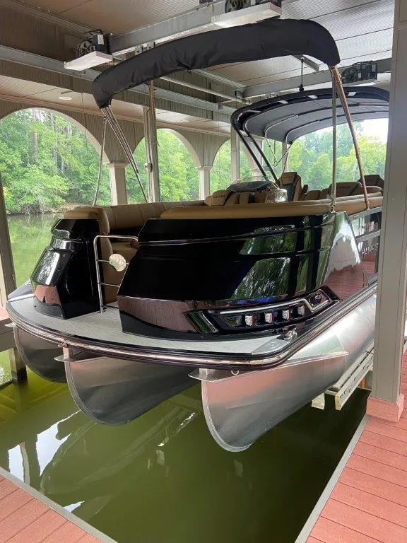 Slide: The Image of 2023 Harris FloteBote 250 Grand Mariner pontoon boat docked in a covered marina. - 19