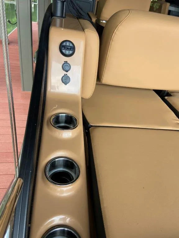 Slide: The Image of 2023 Harris FloteBote 250 Grand Mariner interior with cup holders and beige seating. - 21