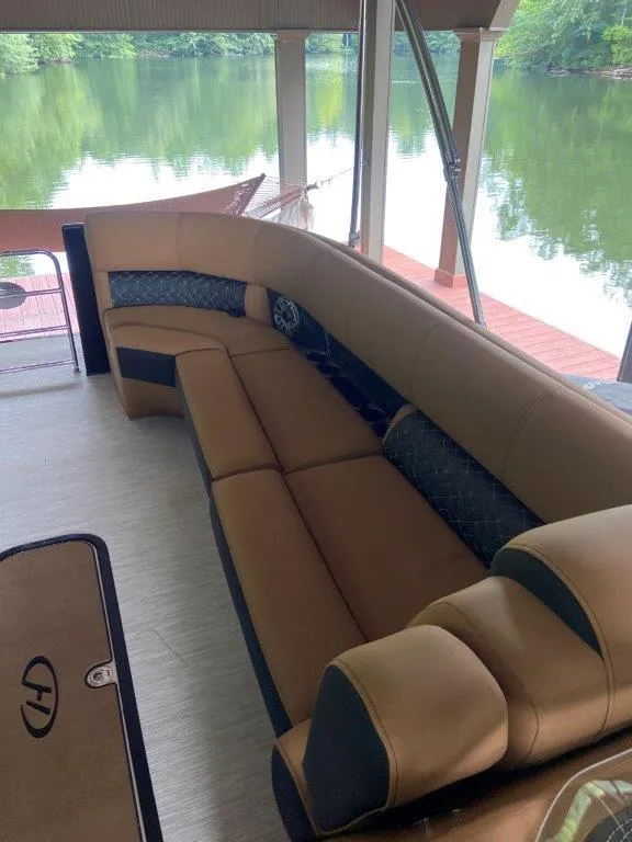 Slide: The Image of 2023 Harris FloteBote Grand Mariner 250 with luxurious seating on a serene lake. - 17