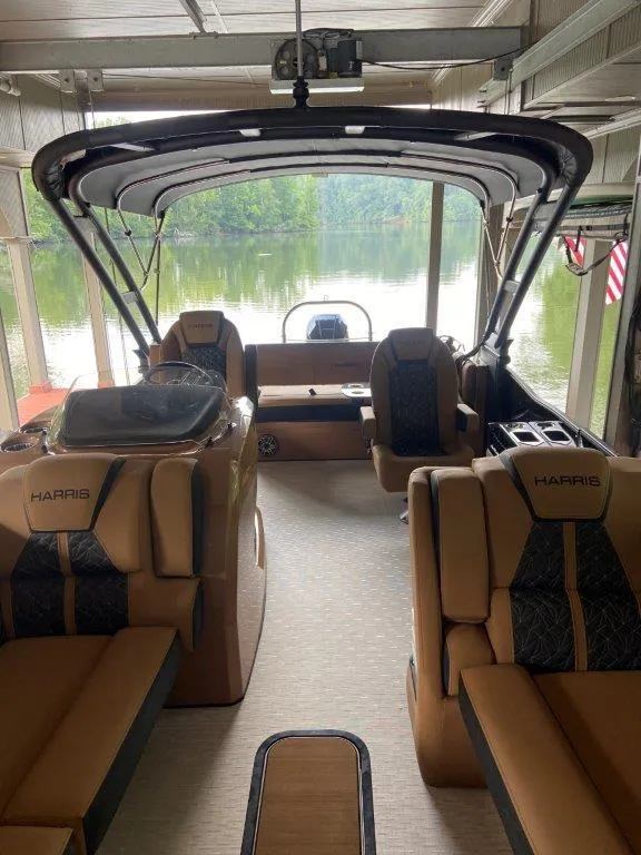 Slide: The Image of 2023 Harris FloteBote Grand Mariner 250 interior with luxurious seating and lake view. - 5