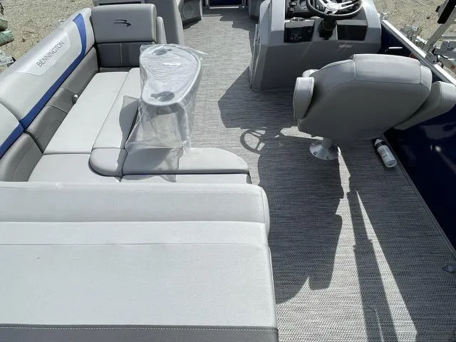 Slide: The Image of 2023 Bennington 20 SXL pontoon boat interior with gray seating and captain's chair. - 4