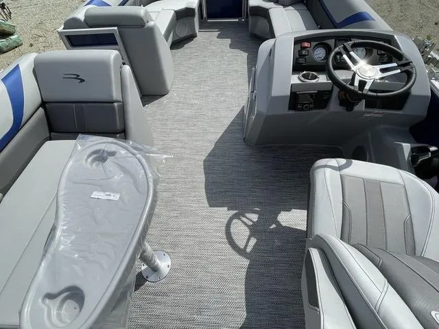 Slide: The Image of 2023 Bennington 20 SXL boat interior with steering console and seating. - 5