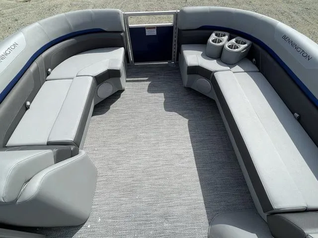 Slide: The Image of 2023 Bennington 20 SXL boat interior with spacious seating and cup holders. - 7