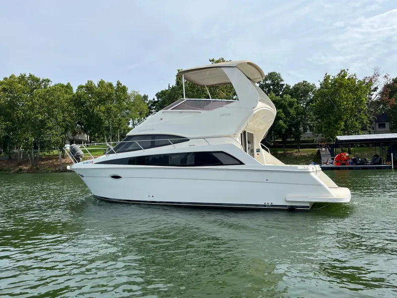 Slide: The Image of 2009 Carver 36SS yacht on a serene lake. - 10