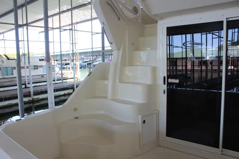 Slide: The Image of 2009 Carver 36SS yacht interior with white stairs and sliding glass door. - 13