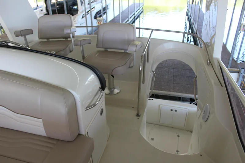 Slide: The Image of 2009 Carver 36SS boat interior with beige seating and helm station. - 19