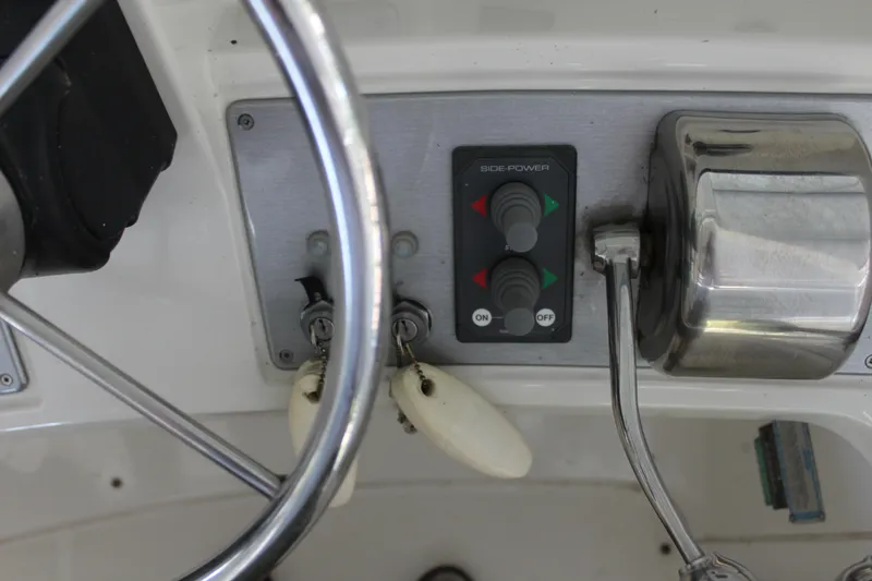 Slide: The Image of Carver 36SS 2009 boat control panel with steering wheel and throttle. - 22