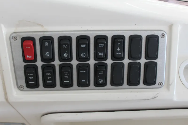 Slide: The Image of Control panel of a 2009 Carver 36SS boat with various switches and buttons. - 23