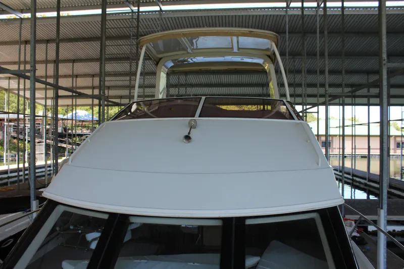 Slide: The Image of 2009 Carver 36SS yacht docked in a covered marina. - 29