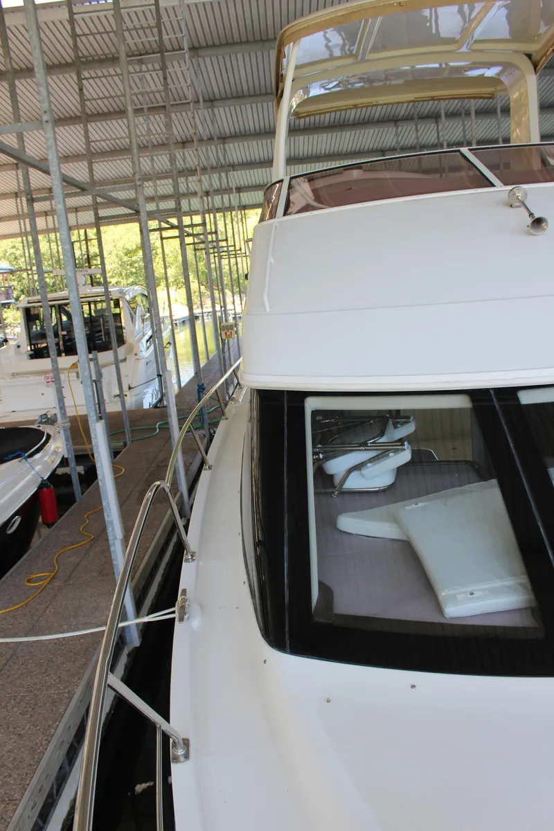 Slide: The Image of 2009 Carver 36SS yacht docked in a covered marina. - 31
