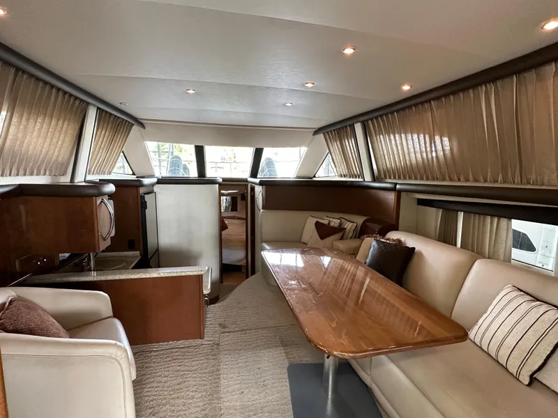 Slide: The Image of 2009 Carver 36SS yacht interior with luxurious seating and dining area. - 33