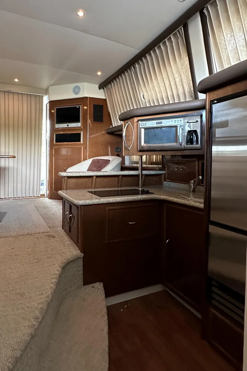 Slide: The Image of Interior of 2009 Carver 36SS yacht with modern kitchen amenities. - 35