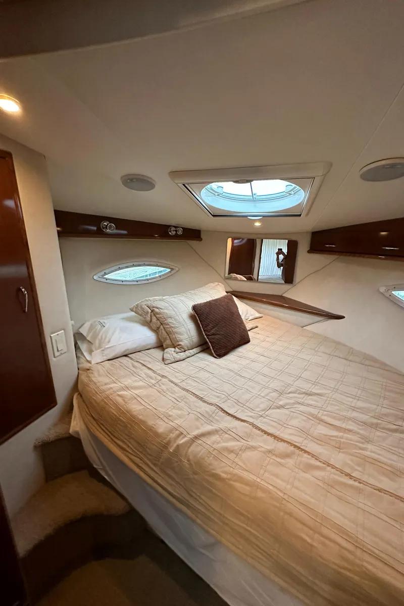Slide: The Image of 2009 Carver 36SS yacht bedroom with skylight and cozy bedding. - 37