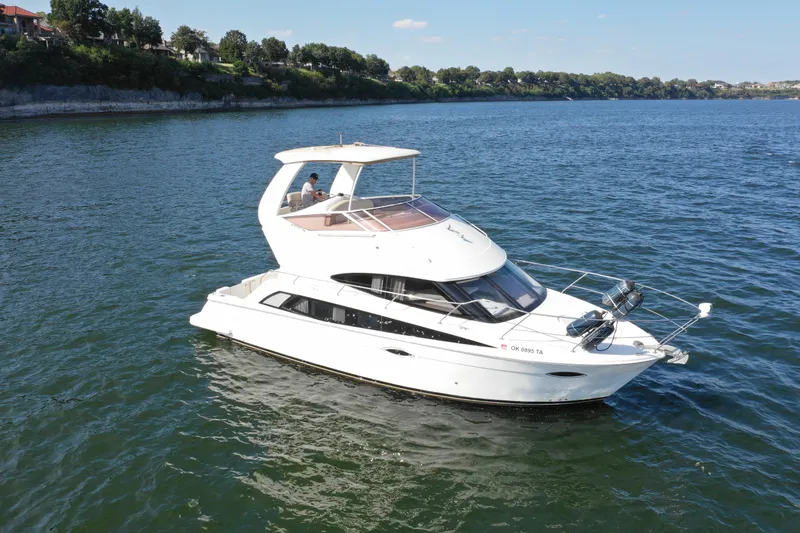 Slide: The Image of 2009 Carver 36SS yacht cruising on a calm lake. - 4