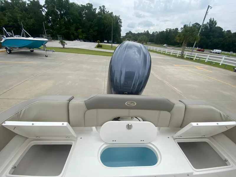 Slide: The Image of 2024 Key West 203 FS boat stern with storage compartments and outboard motor. - 7