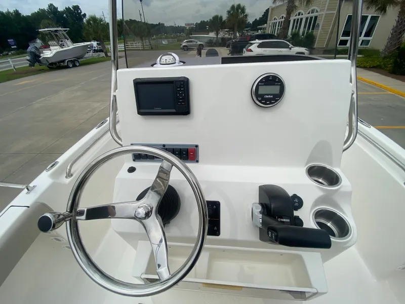 Slide: The Image of 2024 Key West 189 FS boat console with steering wheel, electronics, and cup holders. - 10