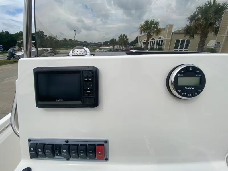 Slide: The Image of 2024 Key West 189 FS boat dashboard with Garmin display and Clarion audio system. - 12