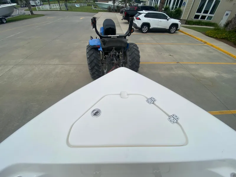 Slide: The Image of 2024 Key West 189 FS boat being towed by a tractor in a parking lot. - 19