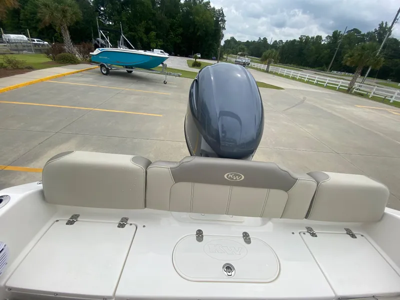 Slide: The Image of 2024 Key West 189 FS boat with outboard motor in parking lot. - 7
