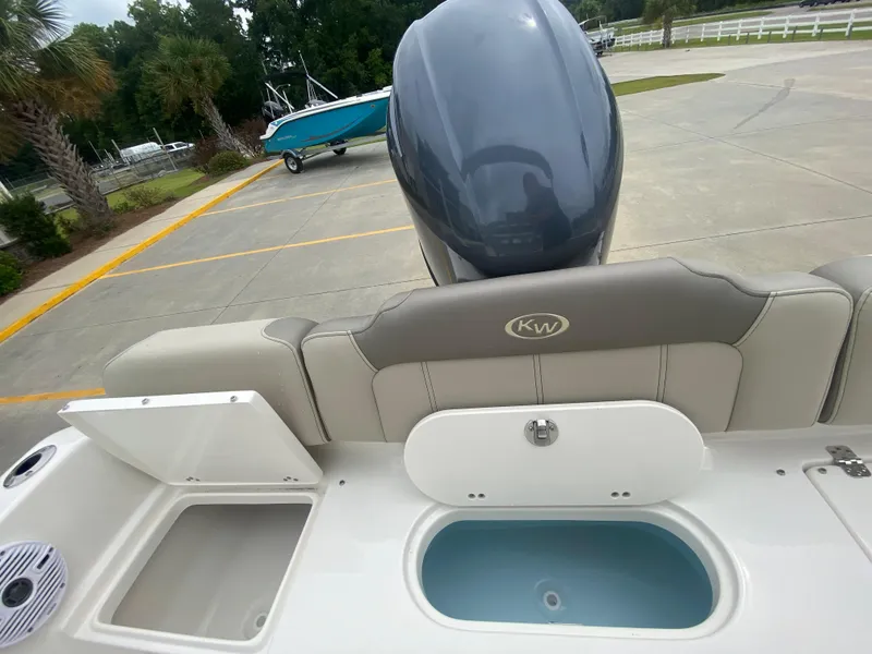 Slide: The Image of 2024 Key West 189 FS boat rear view with motor and storage compartments. - 9