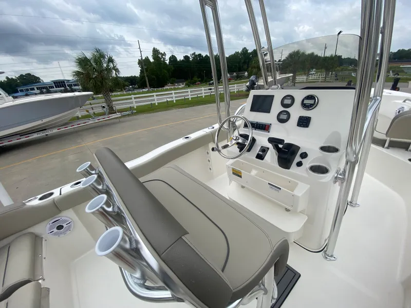 Slide: The Image of 2024 Key West 203 FS boat interior with steering console and seating. - 9