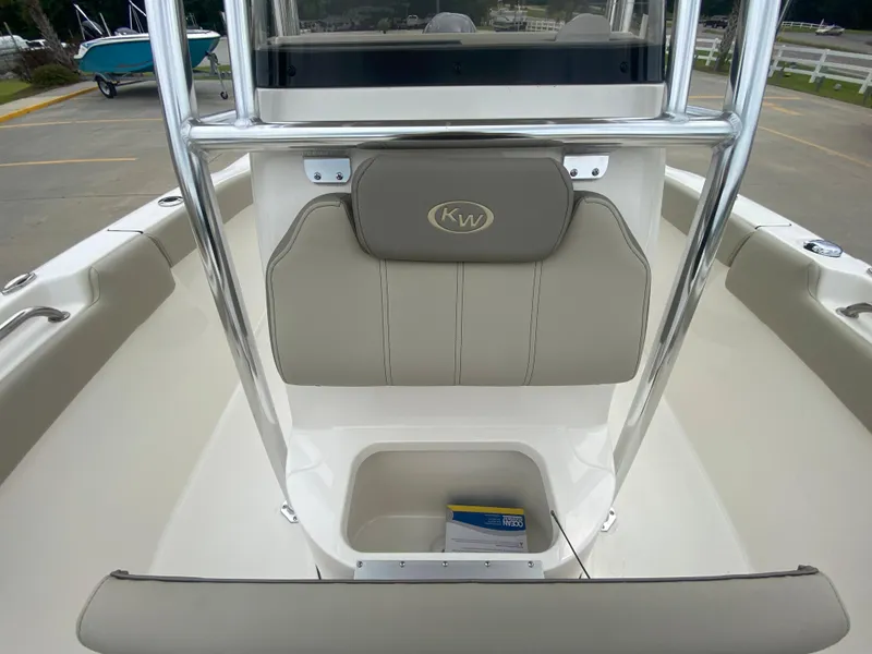 Slide: The Image of 2024 Key West 203 FS boat interior with storage compartment and cushioned seating. - 17