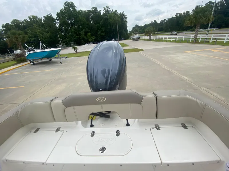 Slide: The Image of 2024 Key West 203 FS boat with outboard motor in parking lot. - 6