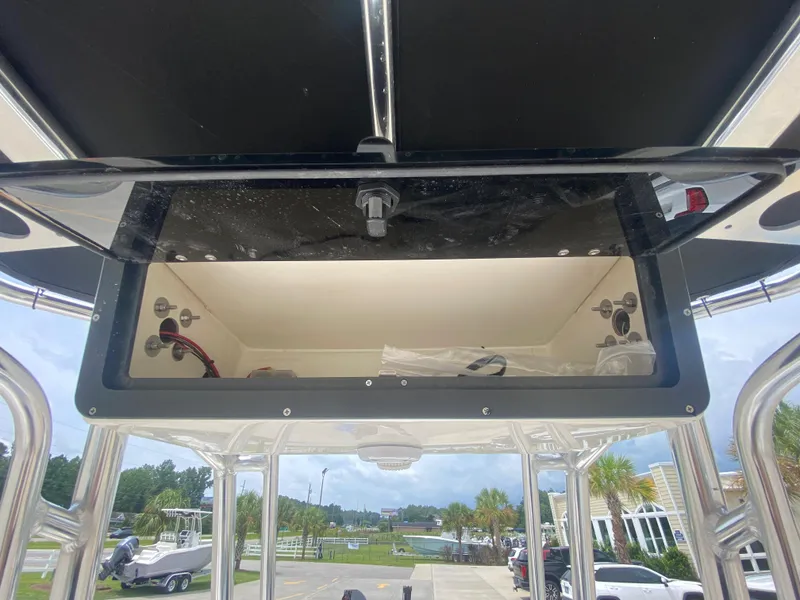Slide: The Image of 2024 Key West 210 Bay Reef boat storage compartment with open lid. - 13