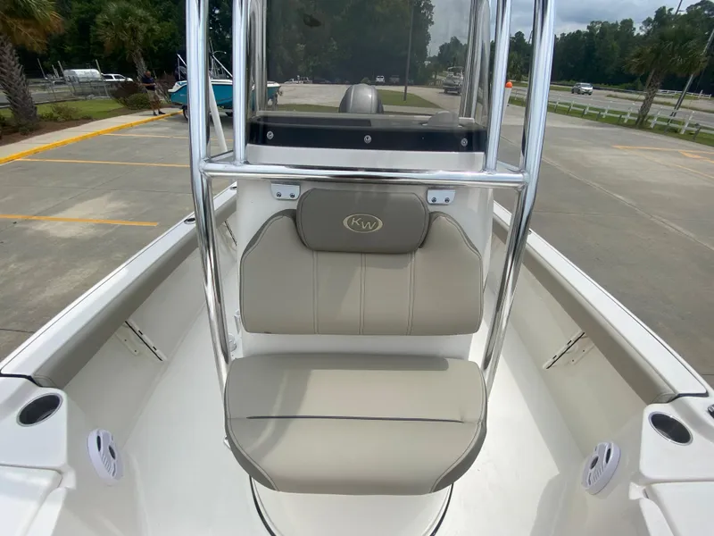 Slide: The Image of 2024 Key West 210 Bay Reef boat interior with cushioned seating and console. - 19