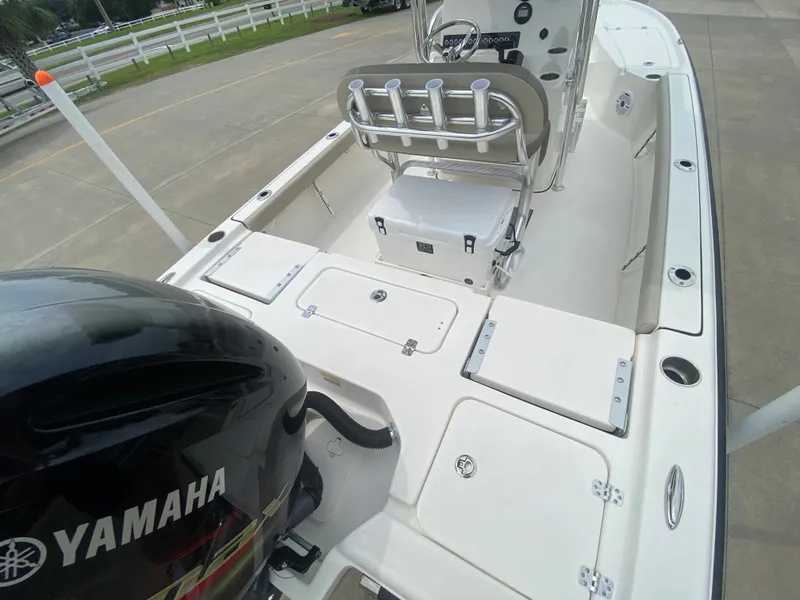 Slide: The Image of 2024 Key West 210 Bay Reef boat with Yamaha engine, spacious deck, and storage compartments. - 5