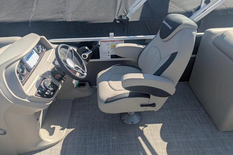 Slide: The Image of Captain's chair and helm of 2023 Berkshire 24 RFX LE pontoon boat. - 11