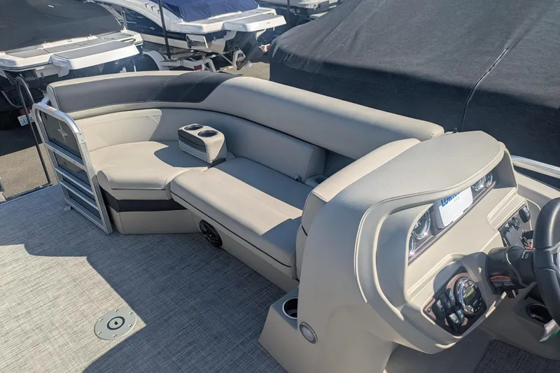 Slide: The Image of 2023 Berkshire 24 RFX LE pontoon boat interior with plush seating and modern dashboard. - 12