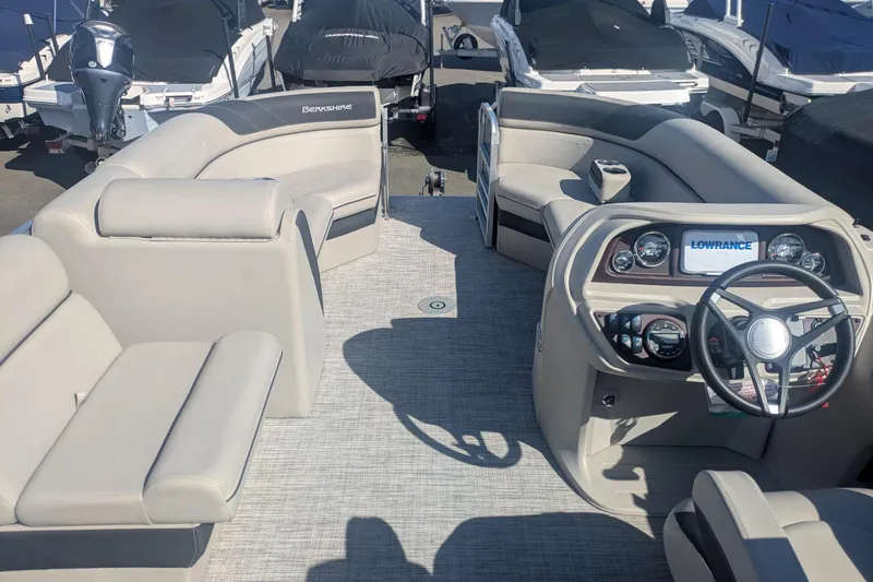 Slide: The Image of 2023 Berkshire 24 RFX LE pontoon boat interior with steering console and seating. - 13
