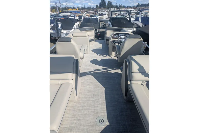 Slide: The Image of 2023 Berkshire 24 RFX LE pontoon boat interior with beige seating and steering console. - 16