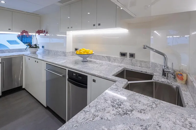 Slide: The Image of Modern kitchen in 2024 Ocean Alexander Revolution yacht with marble countertops and stainless steel appliances. - 28