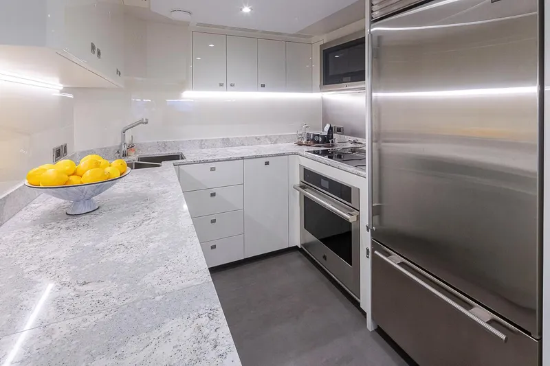 Slide: The Image of Modern kitchen interior on 2024 Ocean Alexander Revolution yacht, featuring sleek appliances and marble countertops. - 29
