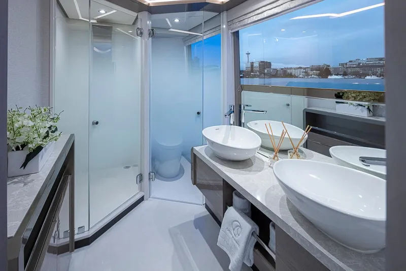 Slide: The Image of Luxurious bathroom on the 2024 Ocean Alexander Revolution yacht with dual sinks and a glass shower. - 32