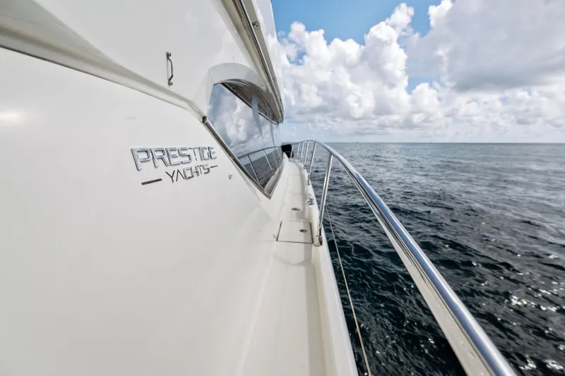 Slide: The Image of 2016 Prestige 620 yacht cruising on open water. - 10