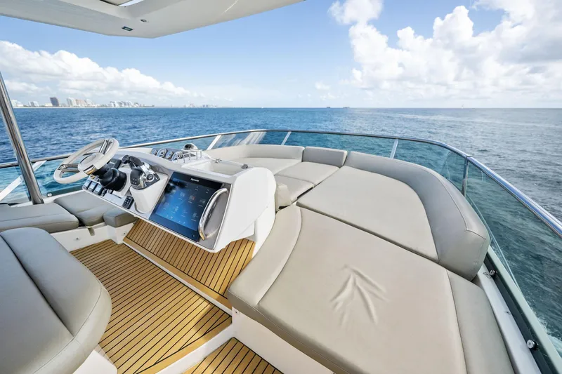 Slide: The Image of Prestige 620 yacht 2016 model, luxurious deck with ocean view and modern navigation controls. - 17