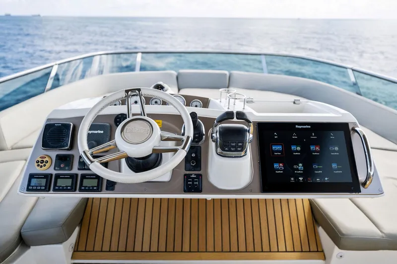 Slide: The Image of Prestige 620 yacht helm station with modern controls and touchscreen display, 2016 model. - 18
