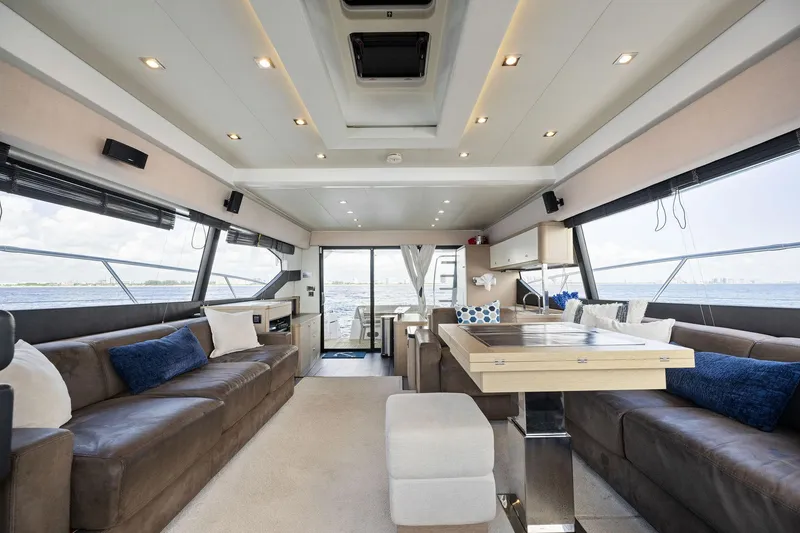 Slide: The Image of Luxurious interior of a 2016 Prestige 620 yacht with modern furnishings and panoramic windows. - 21