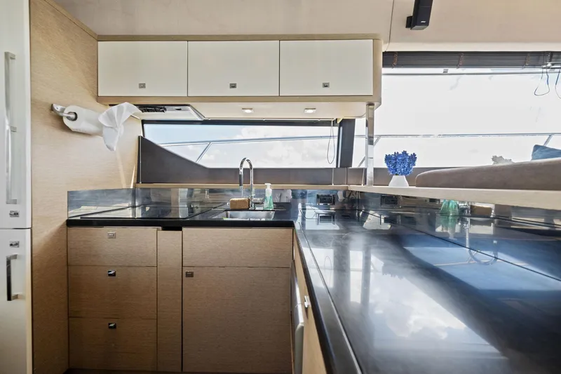 Slide: The Image of Modern kitchen interior of 2016 Prestige 620 yacht with sleek countertops and ample storage. - 23